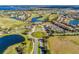 Aerial view of community with golf course, lake, and luxury homes at 14493 Swanley St, Orlando, FL 32832