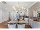 Elegant dining area with glass-top table and chandelier at 14493 Swanley St, Orlando, FL 32832