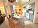 Kitchen with island, white appliances, and gray cabinets at 150 S Carolina Ave, Lake Alfred, FL 33850