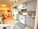 Kitchen with white appliances and gray cabinets at 150 S Carolina Ave, Lake Alfred, FL 33850