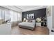 Bright bedroom with a gray platform bed and dark-accent wall at 15810 Shorebird Ln, Winter Garden, FL 34787
