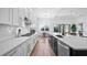 White kitchen with stainless steel appliances and large island at 15810 Shorebird Ln, Winter Garden, FL 34787