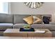 Spacious living room with a light gray sofa and decorative pillows at 1688 Three Bars Rd, Kissimmee, FL 34744