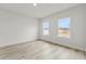 Bright bedroom with two windows and light wood flooring at 16895 Sw 50Th Cir, Ocala, FL 34473