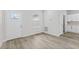 Bright entryway with wood-look floors and adjacent kitchen at 16895 Sw 50Th Cir, Ocala, FL 34473