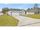 Newly built home with a large front yard and driveway at 16895 Sw 50Th Cir, Ocala, FL 34473