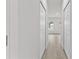 Bright hallway with light wood flooring and doors to bedrooms at 16895 Sw 50Th Cir, Ocala, FL 34473