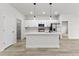 Modern kitchen with white cabinets, quartz countertops, and stainless steel appliances at 16895 Sw 50Th Cir, Ocala, FL 34473