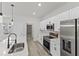 Modern kitchen with white cabinets, quartz countertops, and island at 16895 Sw 50Th Cir, Ocala, FL 34473