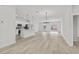 Open floor plan with modern kitchen and wood-look floors at 16895 Sw 50Th Cir, Ocala, FL 34473
