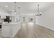 Open concept kitchen and living area with island and pendant lights at 16895 Sw 50Th Cir, Ocala, FL 34473