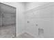 Bright laundry room with built-in shelving and access to garage at 16895 Sw 50Th Cir, Ocala, FL 34473