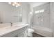 Modern bathroom with gray vanity and marble shower/tub combo at 1707 Merthie Dr, Sanford, FL 32771