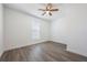 Bright bedroom with wood-look floors and ceiling fan at 1707 Merthie Dr, Sanford, FL 32771