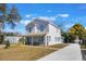 Two-story house with light gray siding, a stone accent, and a long driveway at 1707 Merthie Dr, Sanford, FL 32771
