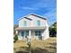 Two-story house with light gray siding, stone accents, and blue window trim at 1707 Merthie Dr, Sanford, FL 32771