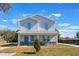 Two-story house with light gray siding, blue trim, and stone accents at 1707 Merthie Dr, Sanford, FL 32771