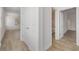 Light hallway with wood-look floors and access to bedrooms and bathroom at 1707 Merthie Dr, Sanford, FL 32771