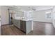 Modern kitchen with gray cabinets, island, and stainless steel appliances at 1707 Merthie Dr, Sanford, FL 32771