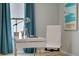 Home office with a white desk, teal curtains, and natural light at 1711 Three Bars Rd, Kissimmee, FL 34744
