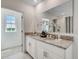 Bathroom with double vanity, granite countertop, and large mirror at 1717 Three Bars Rd, Kissimmee, FL 34744