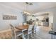 Dining room with wooden table, white chairs, and kitchen view at 1809 Silver Valley Ct, Apopka, FL 32712