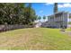 Spacious backyard with healthy green grass, shade trees, and privacy fence at 1875 Staunton Ave, Winter Park, FL 32789
