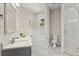 Bathroom featuring white tile, gray floors, a soaking tub and glass shower enclosure at 1875 Staunton Ave, Winter Park, FL 32789