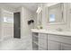 Bathroom featuring gray floors, double sinks, white countertops and dark trim doors at 1875 Staunton Ave, Winter Park, FL 32789