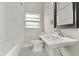 Bathroom featuring black and white tile floors, and a pedestal sink at 1875 Staunton Ave, Winter Park, FL 32789