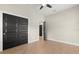 Neutral bedroom with wood-look flooring, a ceiling fan, and large closet doors at 1875 Staunton Ave, Winter Park, FL 32789