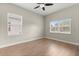Bright bedroom features wood-look floors, neutral paint, and two windows for ample natural light at 1875 Staunton Ave, Winter Park, FL 32789