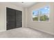 Bedroom with carpeted floors, neutral walls, closet with doors and a window at 1875 Staunton Ave, Winter Park, FL 32789