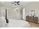 Bedroom featuring ceiling fan, wood floors, neutral walls and a door to the walk-in closet at 1875 Staunton Ave, Winter Park, FL 32789