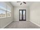 Bedroom with a window, ceiling fan, neutral walls, carpet and doors to a balcony at 1875 Staunton Ave, Winter Park, FL 32789