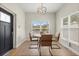 Cozy dining area featuring a round table, four chairs, modern light fixture and natural light at 1875 Staunton Ave, Winter Park, FL 32789
