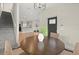 Charming dining area connected to the kitchen with a round table and a view of the stairs at 1875 Staunton Ave, Winter Park, FL 32789