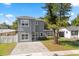 Charming two-story home featuring a gray exterior and a paved driveway at 1875 Staunton Ave, Winter Park, FL 32789