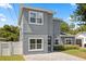 Charming two-story home showcasing a modern gray exterior with white window trim and a paved driveway at 1875 Staunton Ave, Winter Park, FL 32789