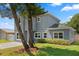 Two-story home featuring a gray facade, white window trim, and a well-maintained front lawn at 1875 Staunton Ave, Winter Park, FL 32789