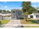 Charming two-story home featuring a gray exterior and a paved driveway at 1875 Staunton Ave, Winter Park, FL 32789