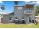 Two-story home with a screened balcony overlooking a grassy yard at 1875 Staunton Ave, Winter Park, FL 32789