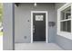 Stylish black front door with a glass insert, complemented by a modern digital lock and a vintage mailbox at 1875 Staunton Ave, Winter Park, FL 32789