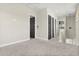 Upstairs hallway with neutral walls and gray carpet, along with doors in a dark finish at 1875 Staunton Ave, Winter Park, FL 32789