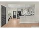 Modern kitchen with gray cabinets, stainless steel appliances, and a breakfast bar, seamlessly connected to the living area at 1875 Staunton Ave, Winter Park, FL 32789
