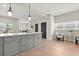 View of the kitchen island with gray cabinets and white countertops, flowing into the living and dining areas at 1875 Staunton Ave, Winter Park, FL 32789