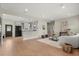 Open-concept living room with hardwood floors, a white sofa, and a view of the modern kitchen at 1875 Staunton Ave, Winter Park, FL 32789