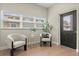 Cozy sitting area with two white chairs, a small table, and a window with natural light at 1875 Staunton Ave, Winter Park, FL 32789