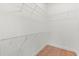 Walk-in closet with white wire shelving and light colored wood floors at 1875 Staunton Ave, Winter Park, FL 32789
