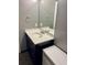 Clean bathroom with dark vanity and a large mirror at 1950 Summer Club Dr # 302, Oviedo, FL 32765